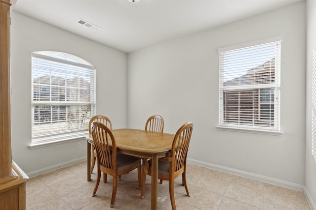 dining space with light tile patterned flooring