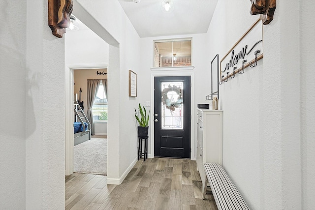 foyer featuring light wood-type flooring and baseboards