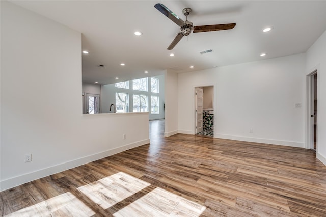 empty room featuring recessed lighting, a ceiling fan, baseboards, visible vents, and light wood-type flooring