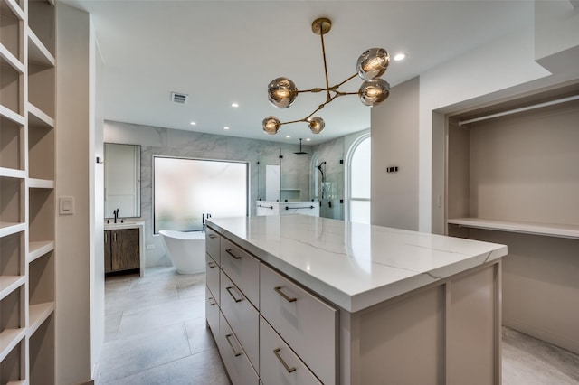 spacious closet featuring visible vents and a sink