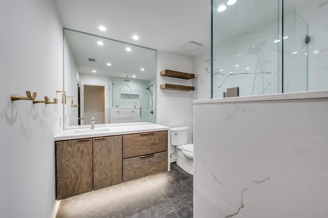 bathroom featuring toilet, recessed lighting, visible vents, vanity, and a marble finish shower