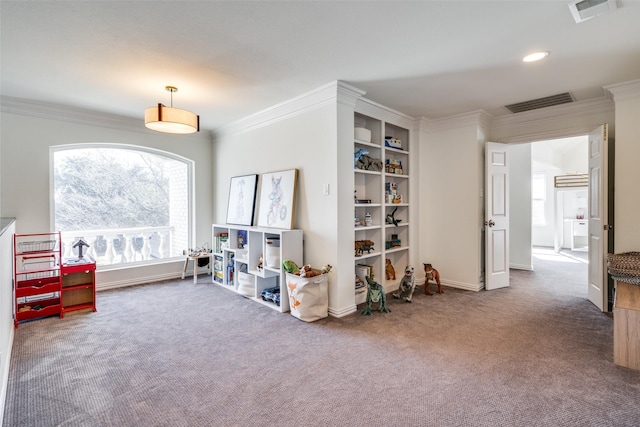 recreation room featuring carpet floors, visible vents, and crown molding