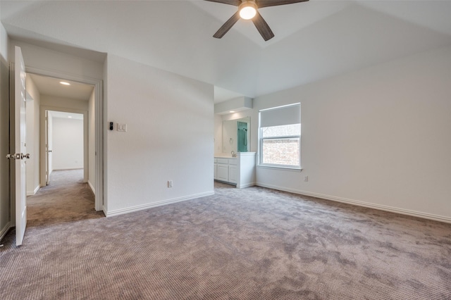 unfurnished bedroom featuring light carpet, connected bathroom, and baseboards