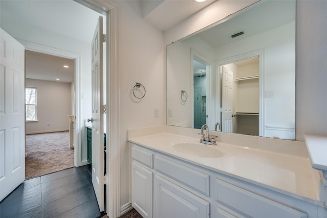 bathroom featuring visible vents, a shower stall, vanity, and baseboards