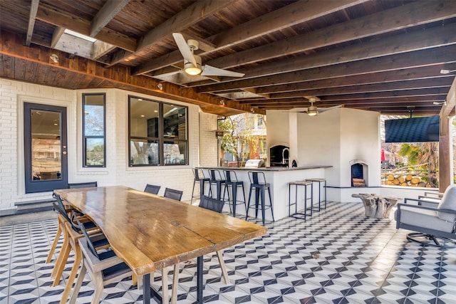 view of patio with a ceiling fan and an outdoor bar