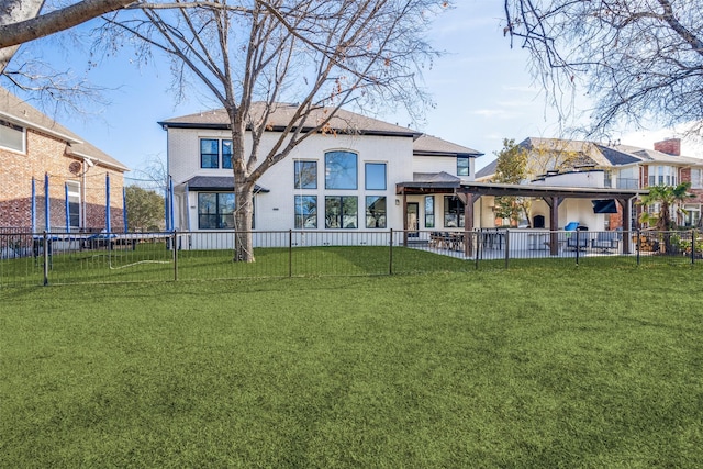 back of house with fence and a lawn