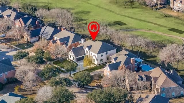 birds eye view of property with view of golf course and a residential view