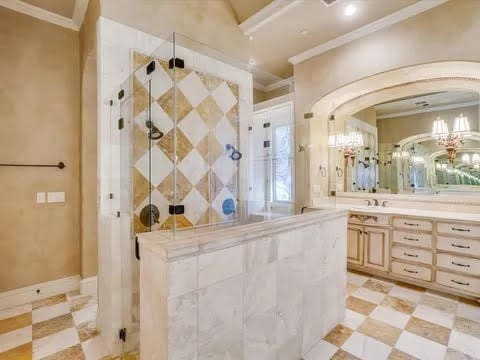 full bath with ornamental molding, a shower stall, vanity, and tile patterned floors