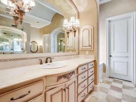 bathroom featuring tile patterned floors, ornamental molding, and vanity