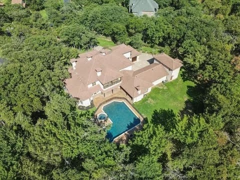 drone / aerial view featuring a wooded view