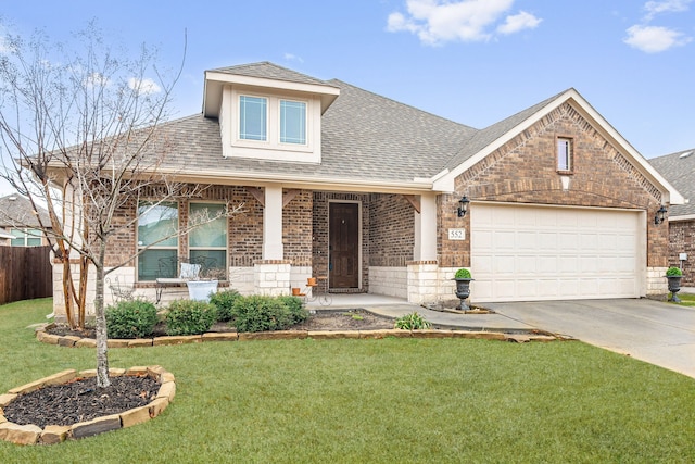 view of front of property featuring a front yard and a garage