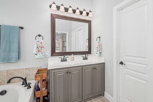 bathroom with tile patterned floors, vanity, and a bathing tub