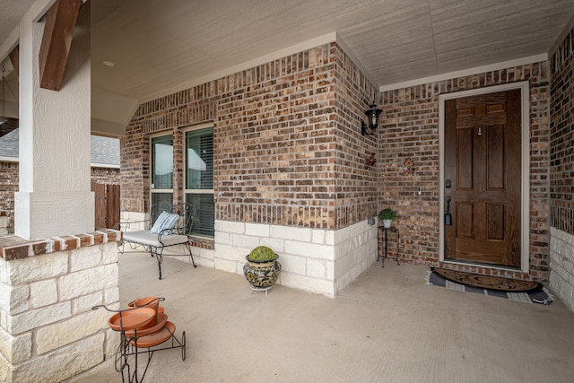 view of exterior entry featuring a porch