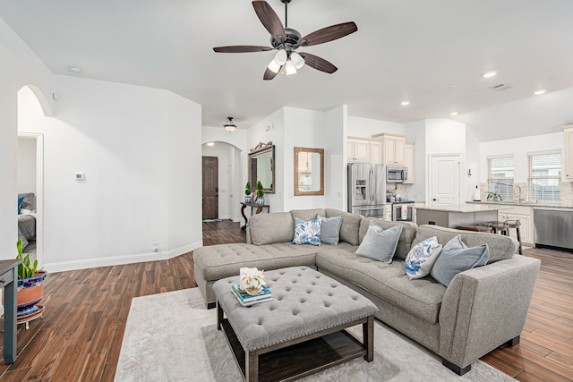 living room with sink, vaulted ceiling, hardwood / wood-style floors, and ceiling fan