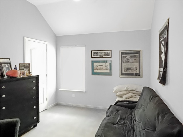 sitting room featuring lofted ceiling and light colored carpet