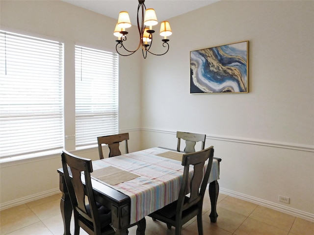 dining room with tile patterned flooring and a notable chandelier