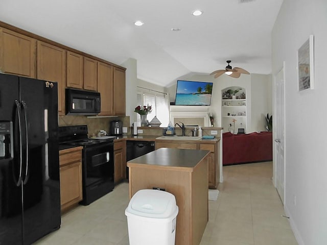 kitchen with built in shelves, black appliances, ceiling fan, a center island, and sink