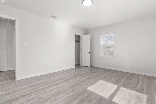 spare room with light hardwood / wood-style flooring