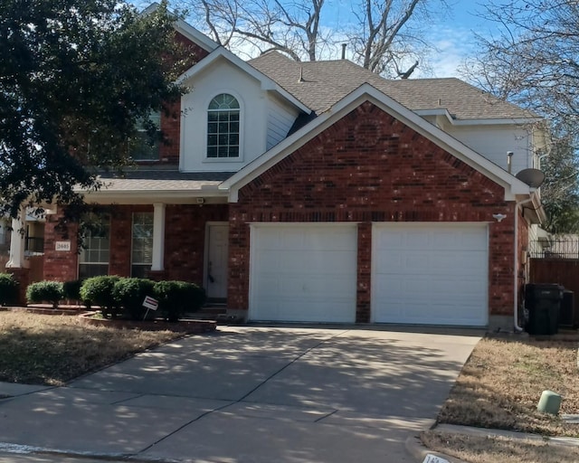 traditional home featuring a garage, driveway, brick siding, and roof with shingles