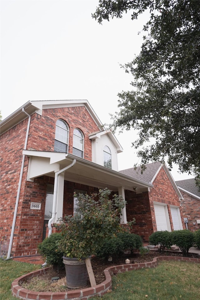 view of front of house with a garage and brick siding