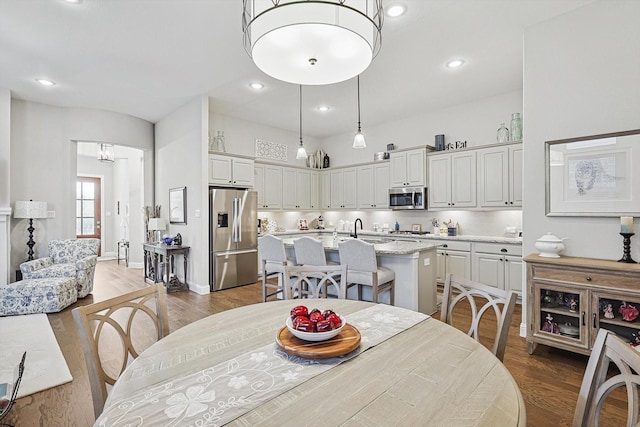 dining area featuring sink and dark hardwood / wood-style floors