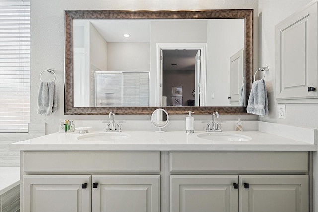 bathroom with vanity and walk in shower