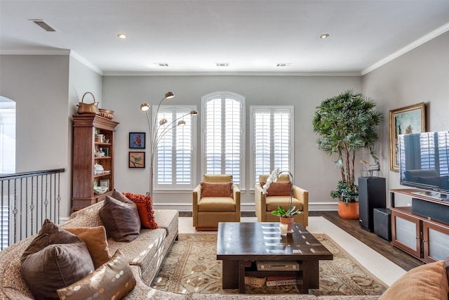 living room with light wood-type flooring and crown molding