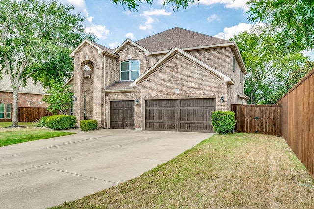 view of front of property featuring a front lawn and a garage