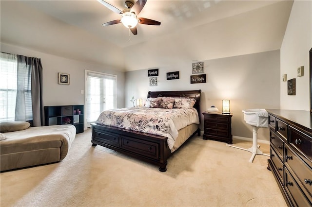 carpeted bedroom with ceiling fan and vaulted ceiling