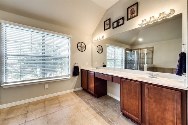 bathroom with vanity, vaulted ceiling, a shower with shower door, and tile patterned floors