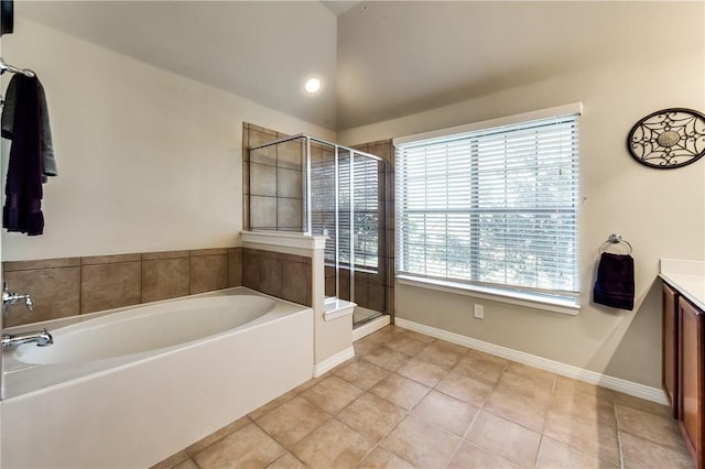 bathroom with tile patterned floors, vanity, plus walk in shower, and lofted ceiling