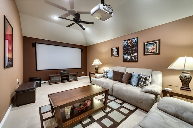 home theater room featuring light carpet, vaulted ceiling, and ceiling fan