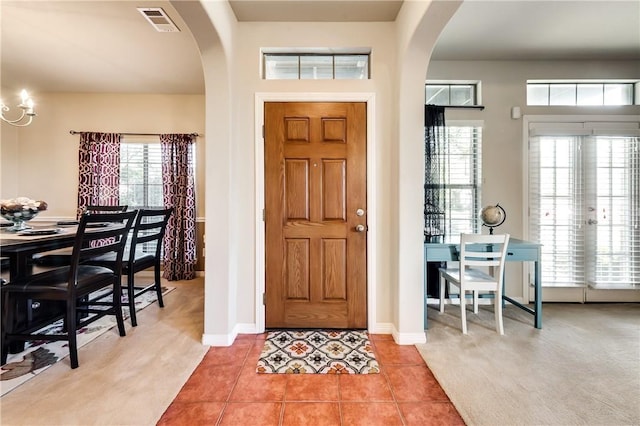 tiled foyer with a healthy amount of sunlight