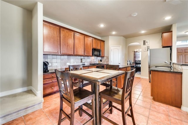 kitchen with light tile patterned floors, sink, and decorative backsplash