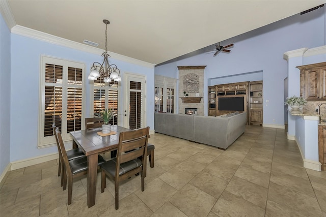 dining space featuring ceiling fan with notable chandelier and crown molding