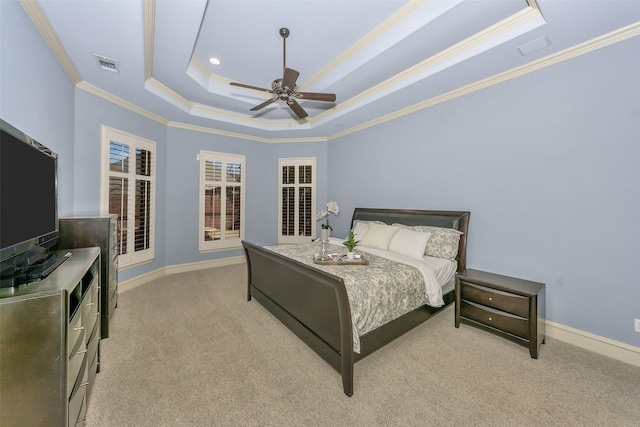 bedroom featuring ceiling fan, crown molding, a raised ceiling, and light colored carpet