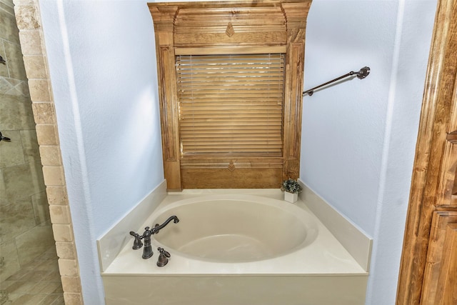 bathroom with a tub to relax in