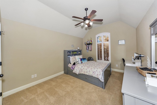 bedroom featuring ceiling fan, vaulted ceiling, and light carpet