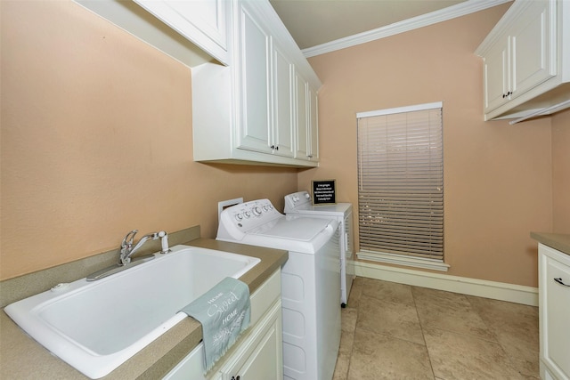 laundry area with washing machine and dryer, crown molding, light tile patterned floors, sink, and cabinets