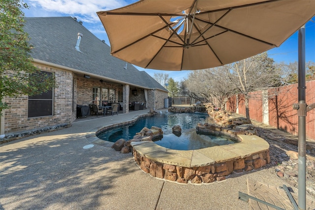 view of swimming pool featuring a patio and an in ground hot tub