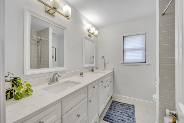 bathroom featuring toilet, tile patterned flooring, and vanity