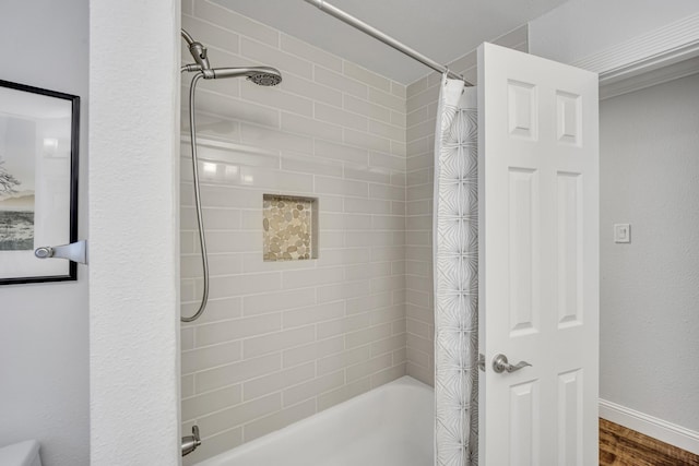 bathroom with shower / bath combination with curtain and wood-type flooring