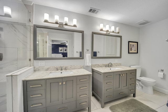 bathroom featuring toilet, ceiling fan, vanity, and walk in shower