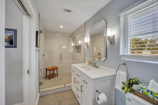 bathroom with vanity and a shower with shower door