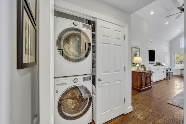 clothes washing area featuring dark hardwood / wood-style flooring, stacked washer and dryer, and ceiling fan