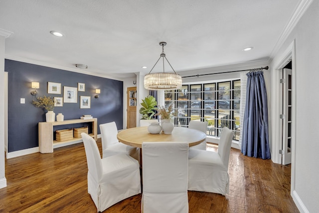 dining room featuring ornamental molding, a chandelier, and dark hardwood / wood-style flooring