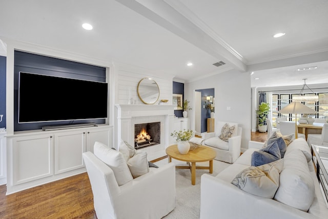 living room with hardwood / wood-style floors and crown molding