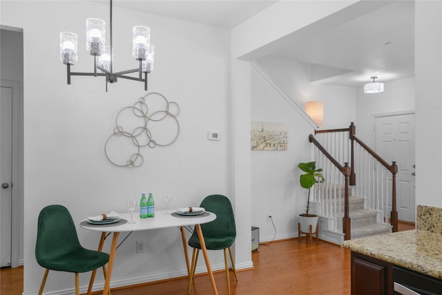 dining room featuring hardwood / wood-style floors and a notable chandelier