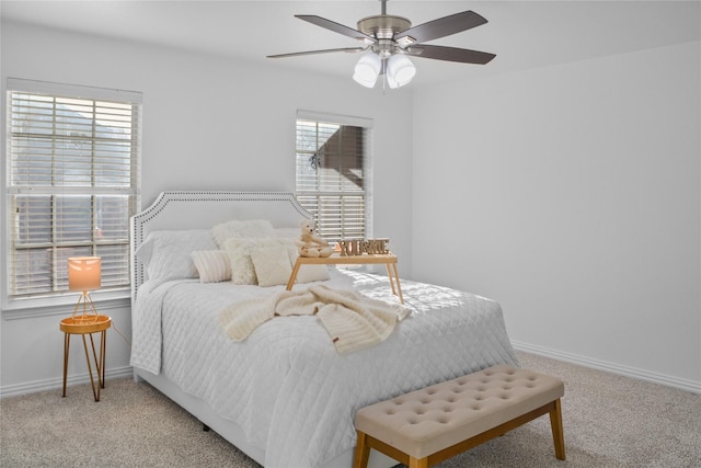 bedroom featuring light carpet, multiple windows, and ceiling fan