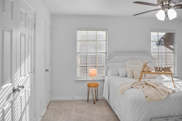 bedroom featuring ceiling fan and light carpet